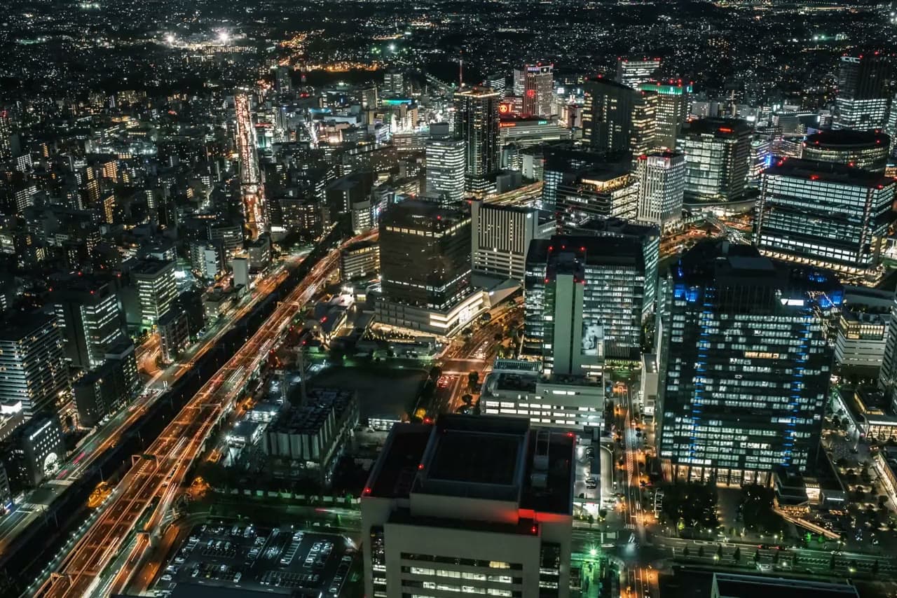 Aerial view of a financial-district skyline lit up at night